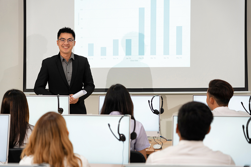 Man in suit presenting to audience.