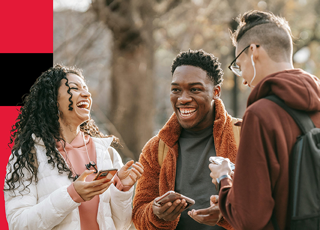 Three young people chatting outdoors, ready to study, live or work abroad.